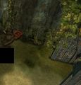 After passing through the gate, on the crates to the right.