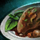 Plate of Coq Au Vin with Mint Garnish.png