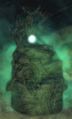 An ancient Statue of Melandru in The Ruined City of Arah, heavily weathered down, corrupted by Zhaitan, powered up by a fragment of the Bloodstone.